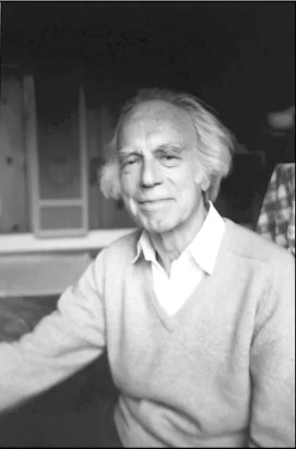 Black-and-white portrait of Jean Klein seated in a light-coloured cardigan.
